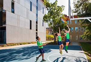 Residents playing basketball at the UniHall court