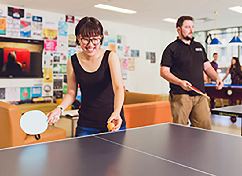 UniHallers playing table tennis and pool in the games room