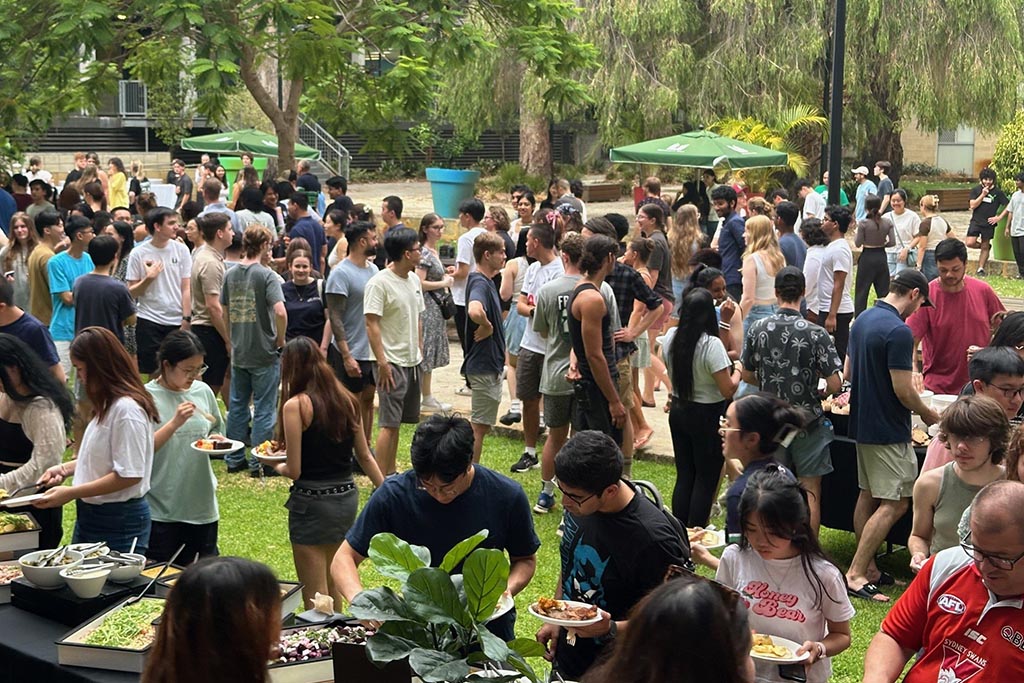 Students gathering at outdoor welcome barbecue