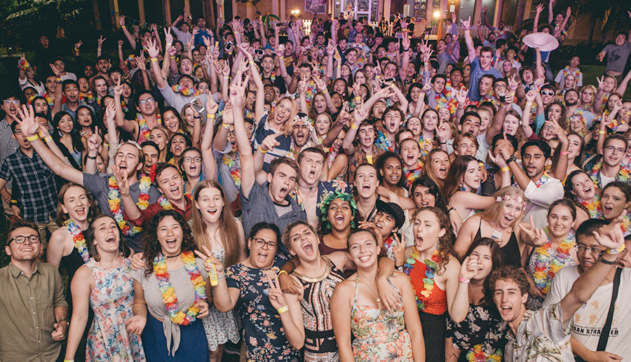 Residents at the commencement event cheering at the front of the stage to the band