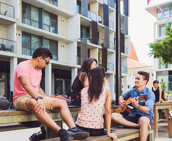 Image of students spending time together in the lower quad