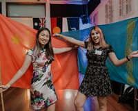 Image of two students posing with the Chinese national flag and the Kazakhstan national flag on international night 