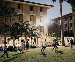 Image of people playing evening soccer in the upper quad