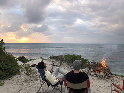 Hamed and friend chilling out on the coast with a campfire