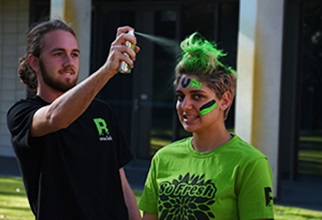 UniHaller getting her hair sprayed in the green college colour