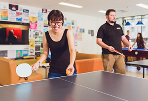 UniHallers playing table tennis and pool in the games room