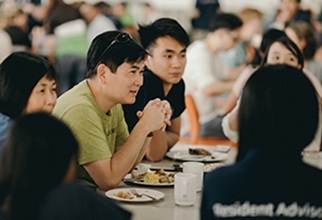 Residents having discussion around Dining Hall table