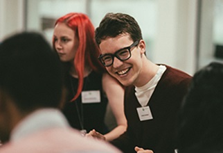 Academic Team member laughing at faculty dinner