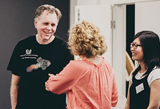 Professor Barry Marshall shaking hands with female resident at leadership event