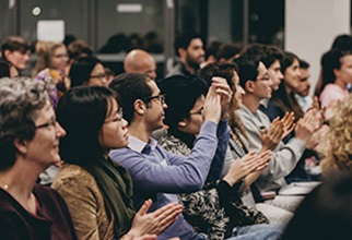 A row of residents clapping after the leadership presentation