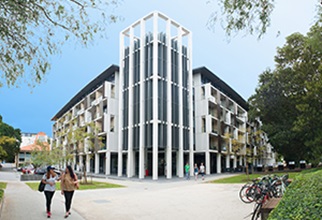 Front view of University Hall with residents walking to and from class