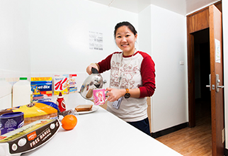 Female resident in standard room common kitchen