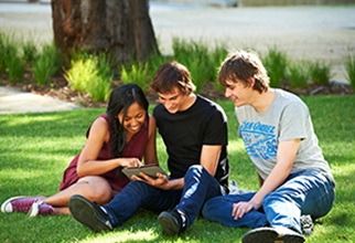 Residents sitting on grass area at from of UniHall