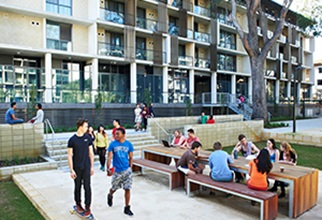 Lots of residents hanging out at picnic tables and skating through the lowerquad