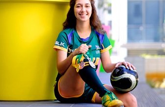 female soccer player with medals