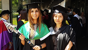 UniHaller and valedictorian leading the graduates to the ceremony