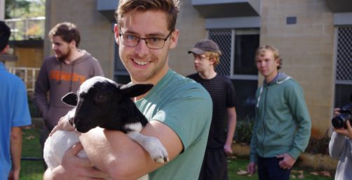 Student holding a small animal
