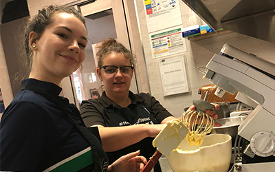 Image of two residents with the electric mixer