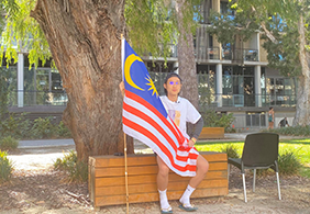 Image of student holding their nation flag for the multicultural video filming